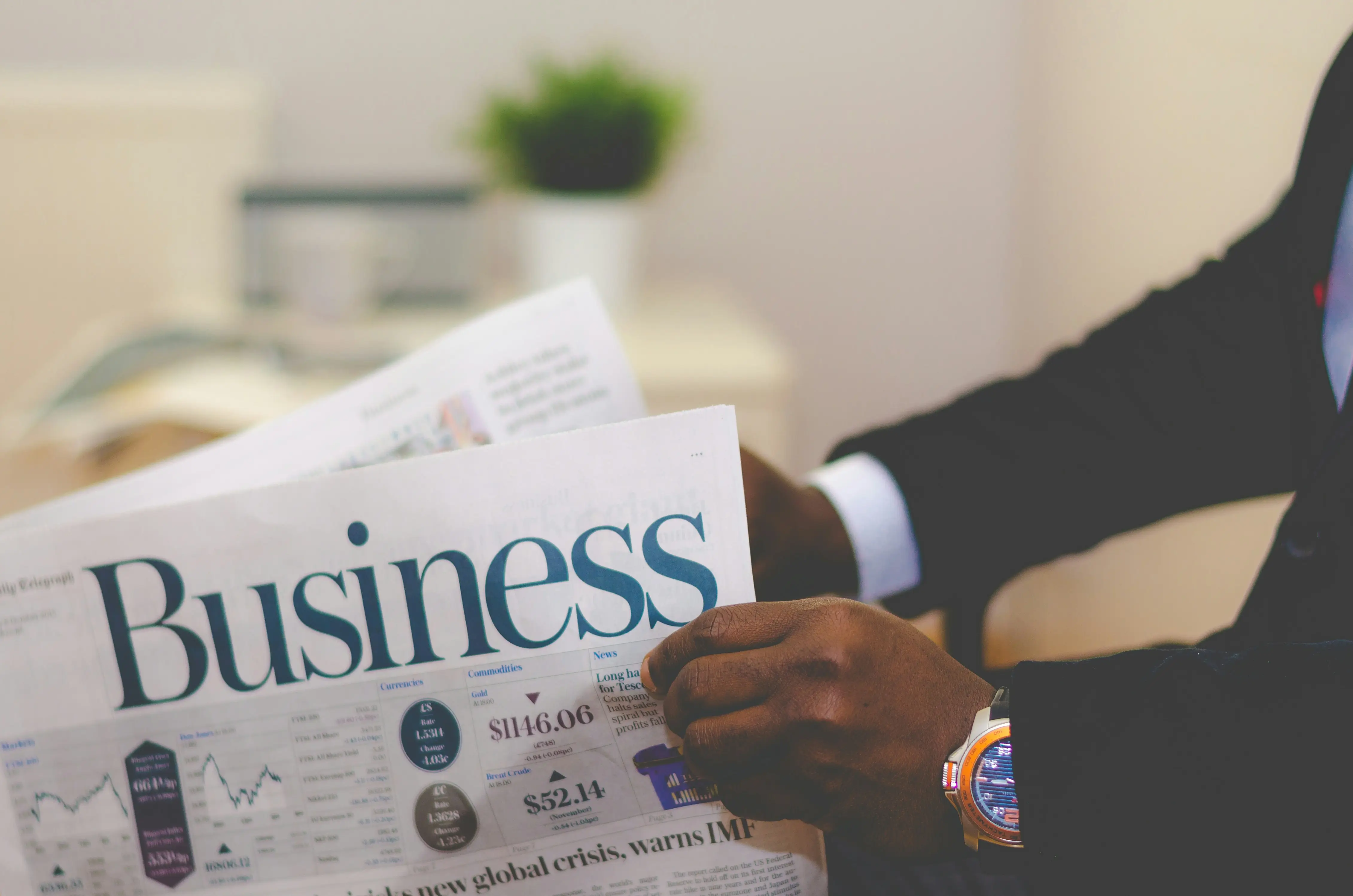 A business owner reading the financial pages